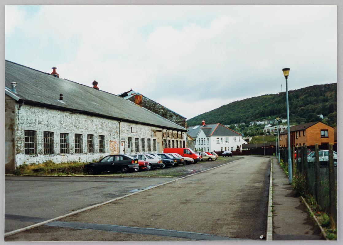 Pontardawe tinplate works, Pontardawe, showing assorting room south façade with gable end of tinhouse beyond, and the main west façade of Gilbertson & Co's general offices in background on Ynysderw Road, October 1994.