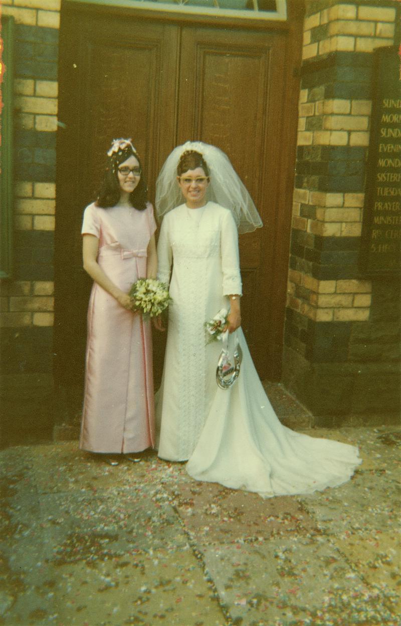 Miss Diane Grubb and Bridesmaid outside baptist chapel, Church Village, on her marriage to Mr CR Williams, 1969