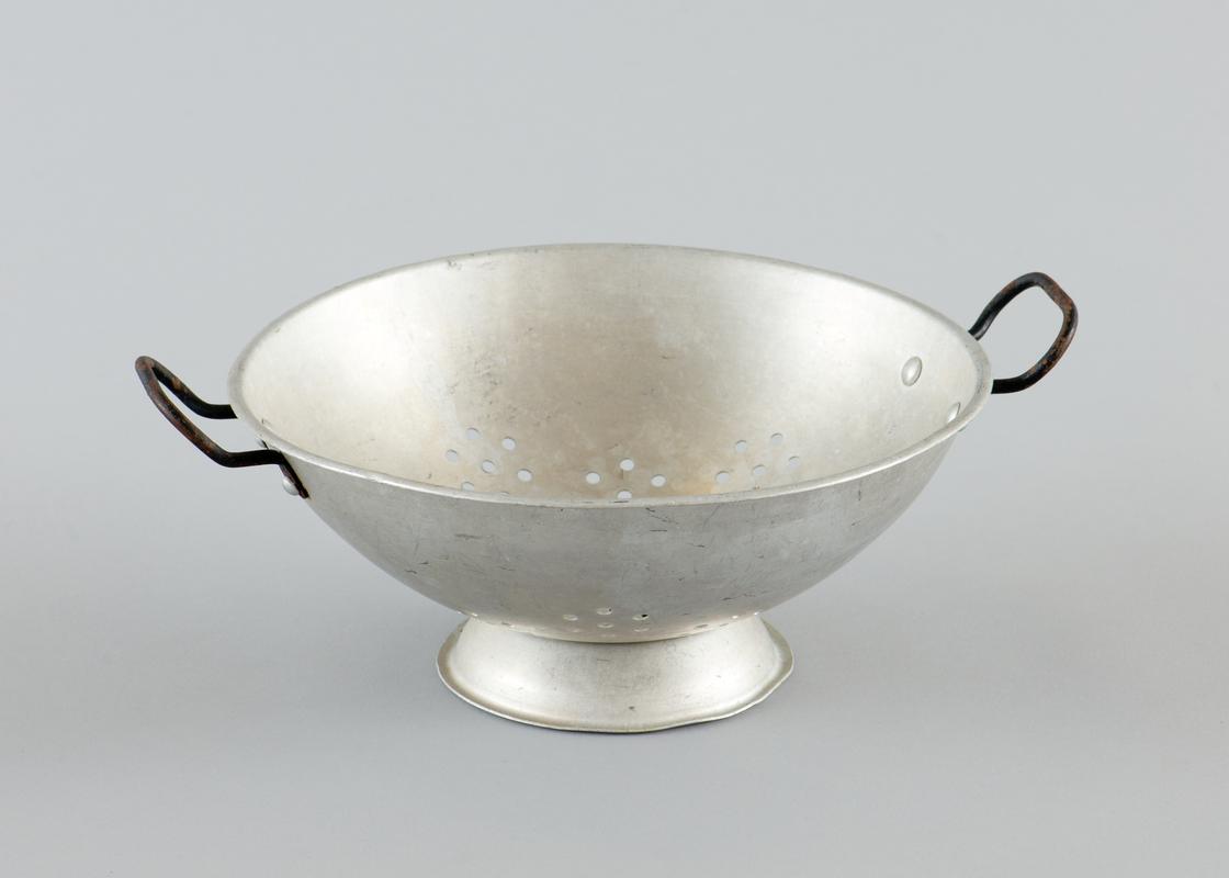 Aluminium colander, with metal handles on either side.