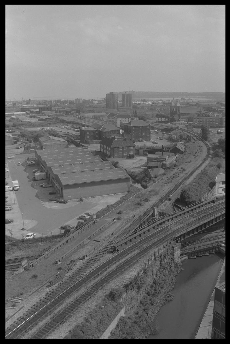 View of Butetown from Bute Terrace, with railway junction from Queen Street and main line in foreground, and flats with Penarth Head in background. Tyndall Street Industrial Area is on the right.