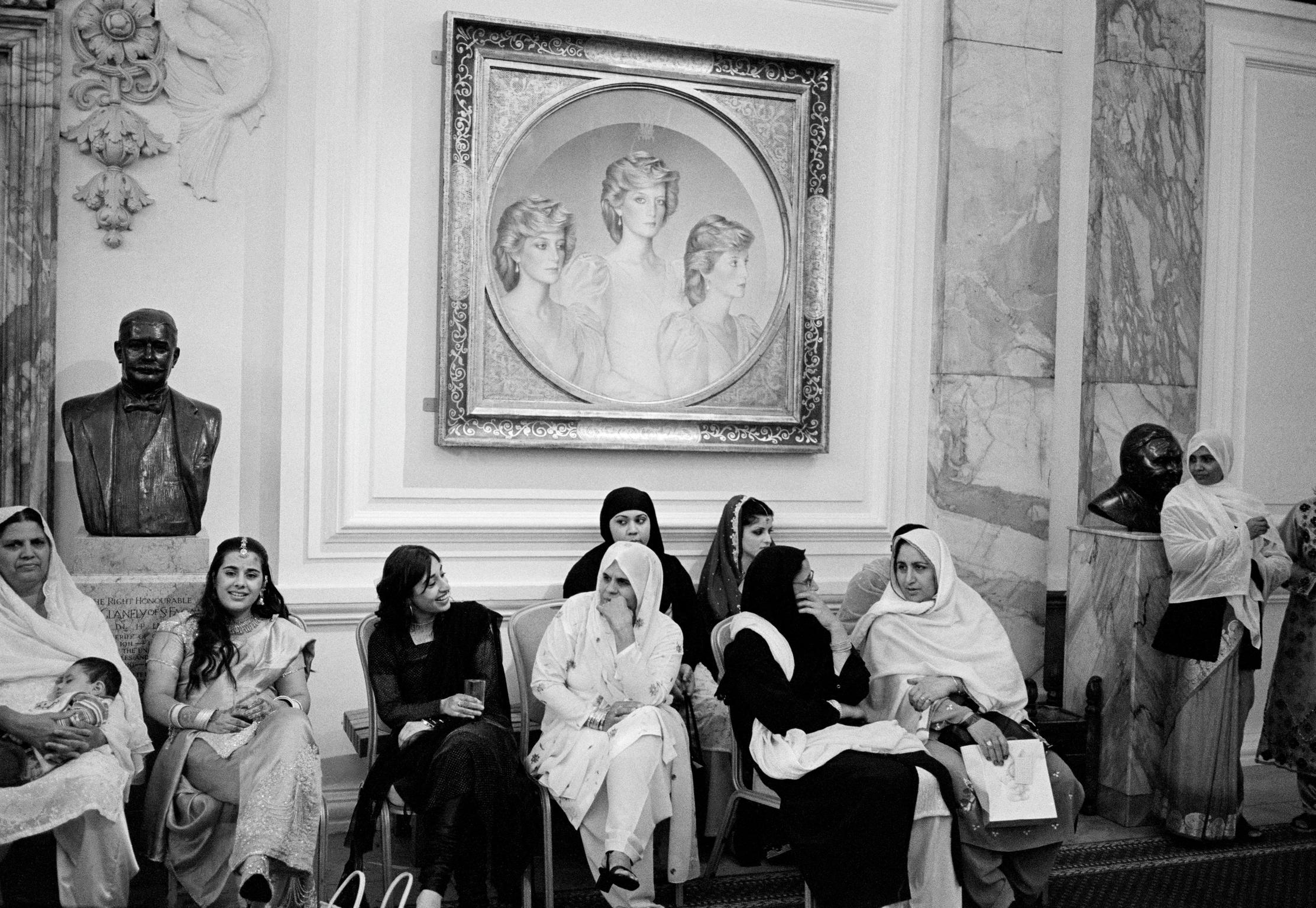 Asian wedding guests in the City Hall Cardiff, Wales. Princess Di looks on.