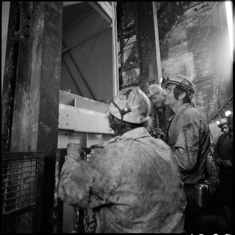 Black and white film negative showing men carrying out maintenance work at the skip at pit bottom, Lady Windsor Colliery.