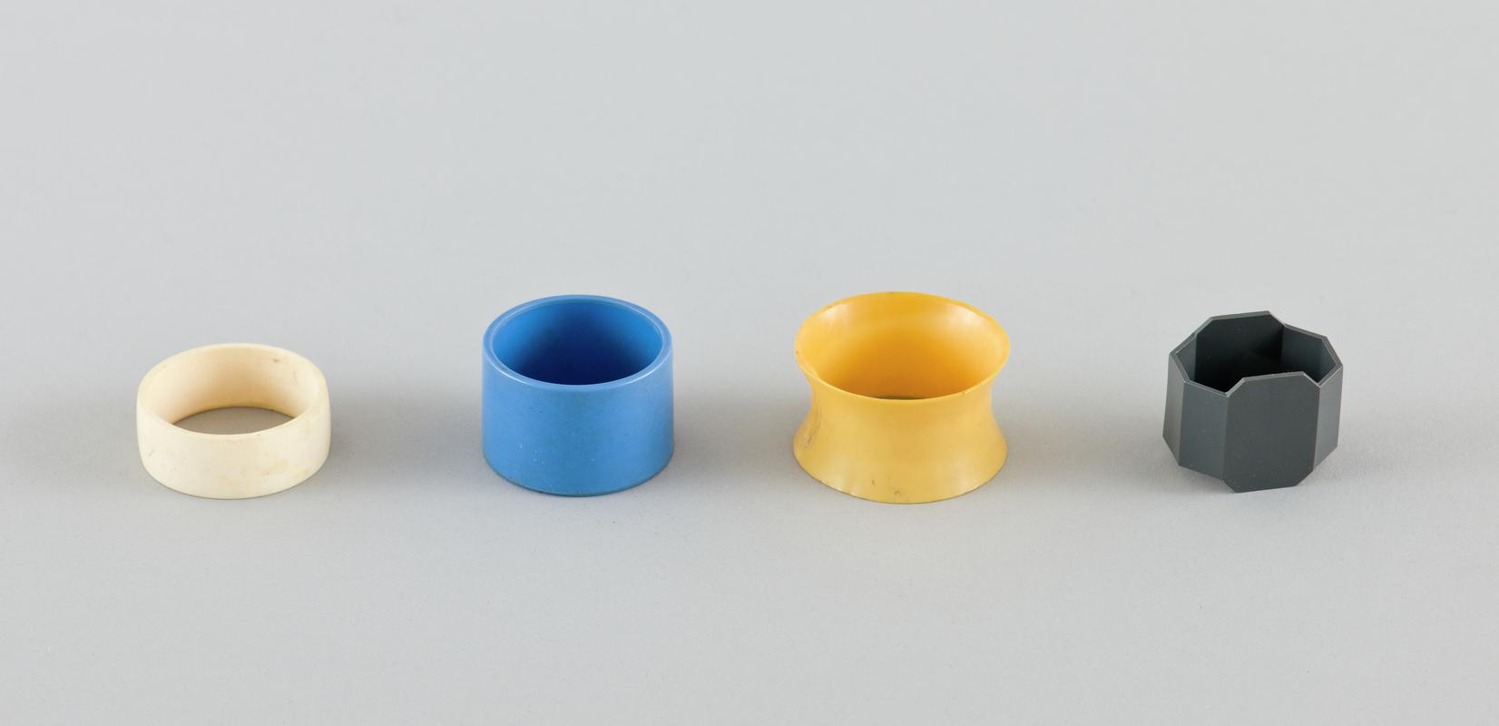 Yellow, white, blue and grey plastic napkin rings.