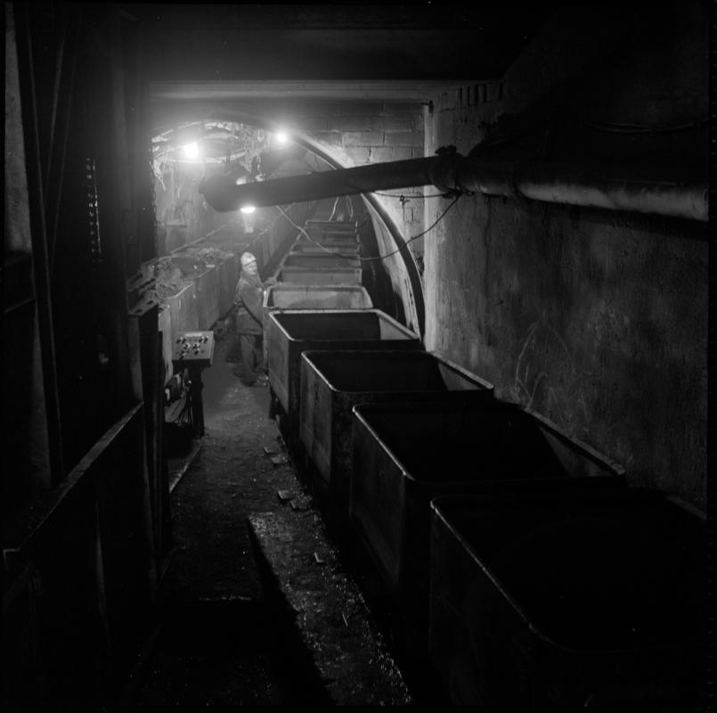 Black and white film negative showing pit bottom before modernisation, with empty drams on a creeper, Lady Windsor Colliery.