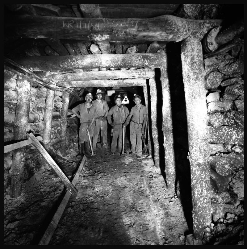 Black and white film negative showing four men at a timbered face, Merthyr Vale Colliery, 2 July 1981.
