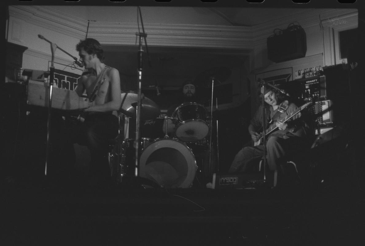 Guitarist and other members of TNT Group on stage. Location unknown.