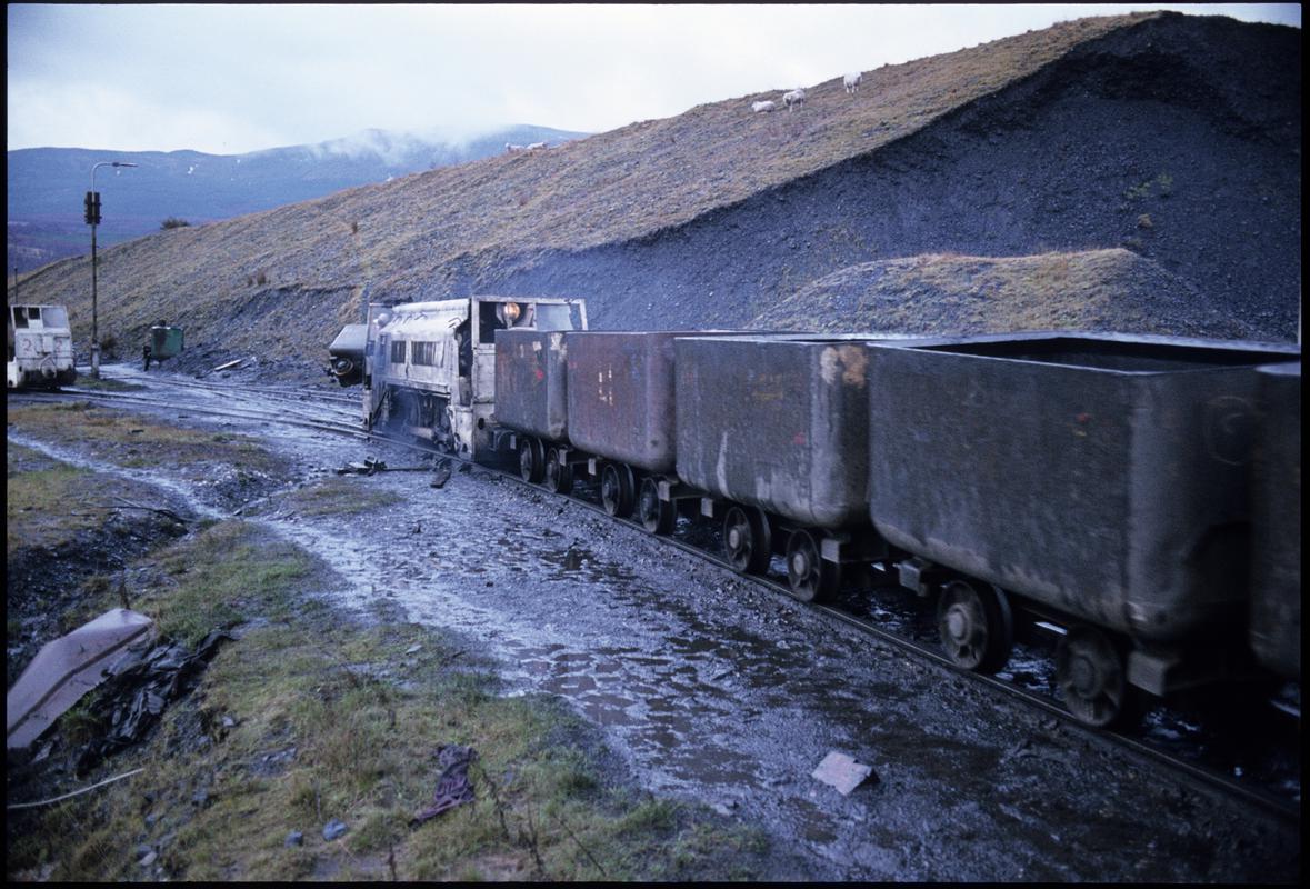 Colour film slide showing a locomotive and journey of drams at Blaengwrach Mine.