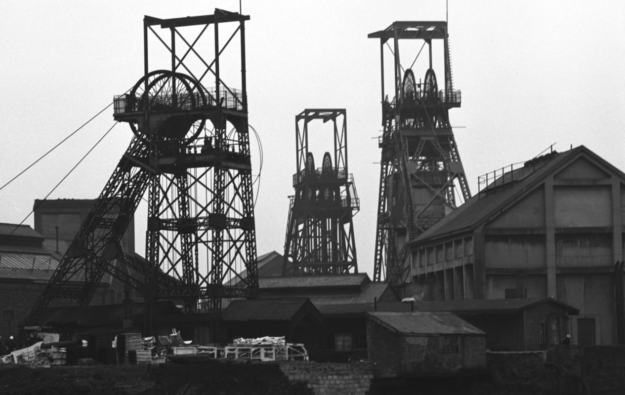 Black and white 35mm film negative showing head frames at Oakdale Colliery, 1975. The headframe in the foreground is the Waterloo or house coal pit.