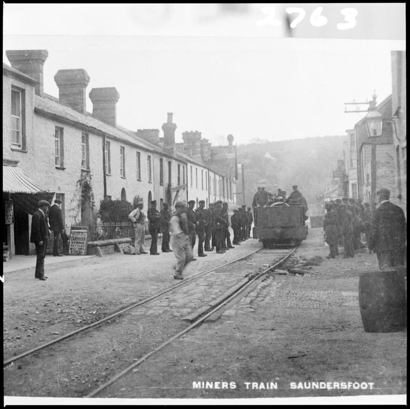 Black and white film negative showing a miners train, Saundersfoot.  'Miners train Pembroke' is transcribed from original negative bag.