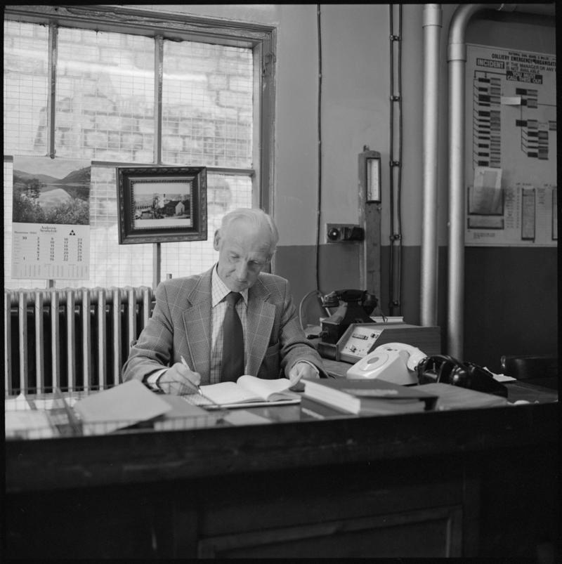 Black and white film negative showing Glyn Morgan, the last NCB manager, in his office, Big Pit Colliery 28 November 1980.  '28 Nov 1980' is transcribed from original negative bag.