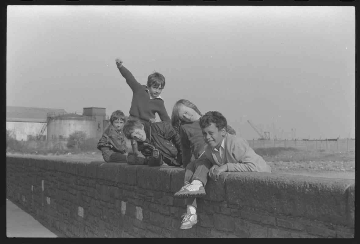 Five children sitting on wall (foreshore) bordering Windsor Esplanade.