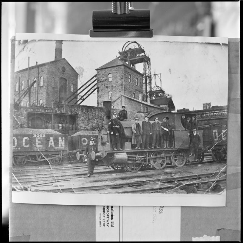 Black and white film negative of a photograph showing a group of men, some policemen, stood on a locomotive, Deep Navigation Colliery.  'Deep Navigation' is transcribed from original negative bag.