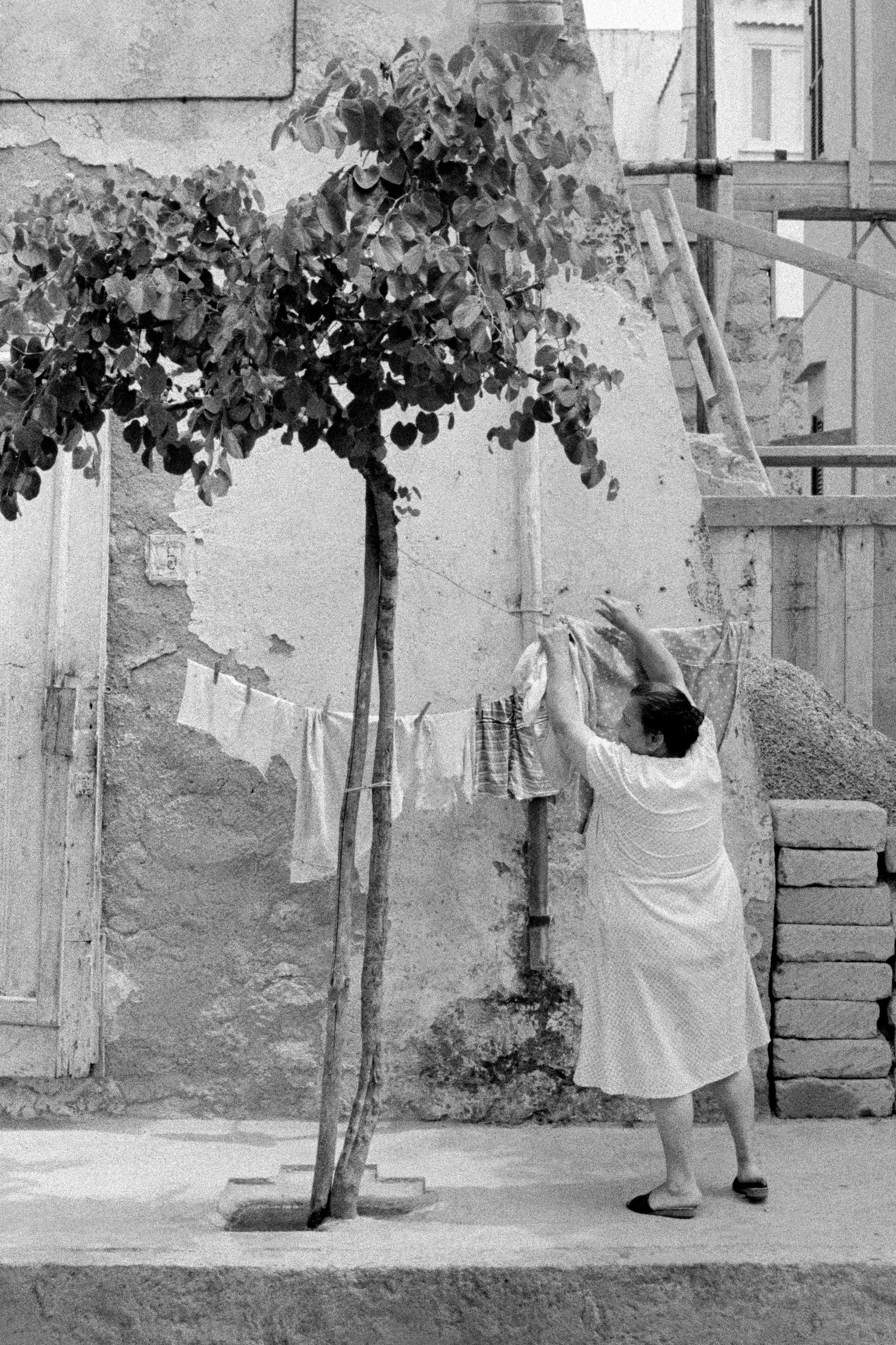 Hanging the washing in a side street. Ischia. Italy