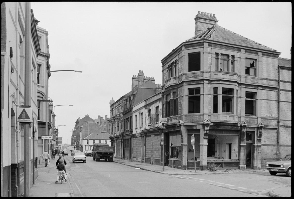 View looking east along James Street, Butetown. No.43, Patterson's butcher's shop lies derelict at the junction with South William Street.
