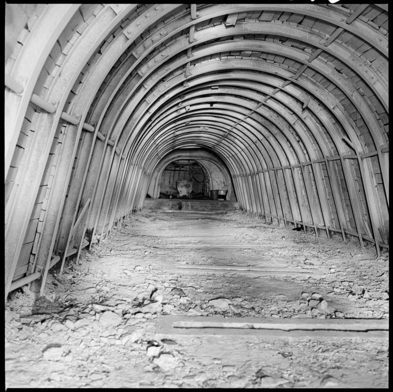 Black and white film negative showing an underground roadway with dram in the distance, Merthyr Vale Colliery.