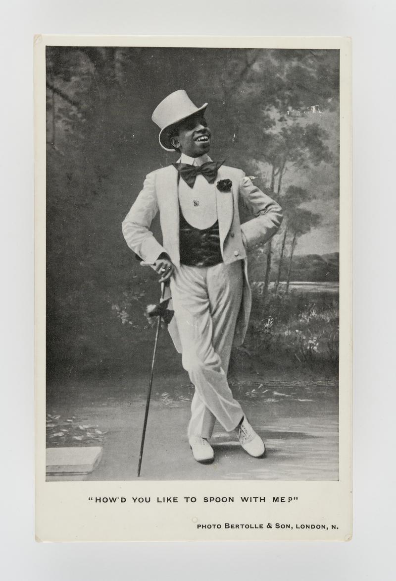Photograph of a coloured minstrel (in white top hat & tails). Title: "How'd you like to spoon with me?".  Posted in Whitland.