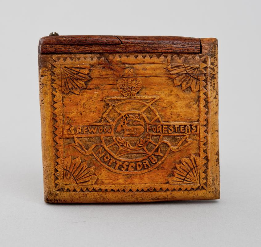 Crudely carved wooden cigarette case