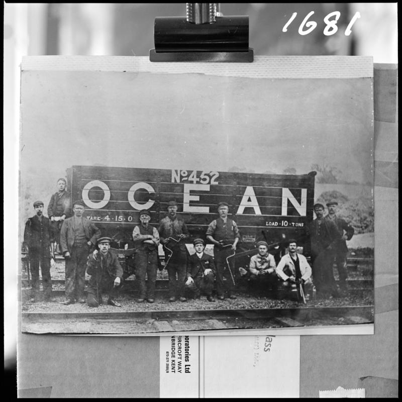 Black and white film negative of a photograph showing a  group of men stood in front of a coal wagon (No. 452), Deep Navigation Colliery.