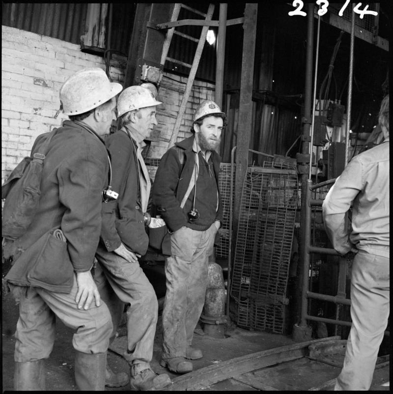 Black and white film negative showing miners waiting at pit top, Morlais Colliery 13 May 1981.  'Morlais 13/5/81' is transcribed from original negative bag.