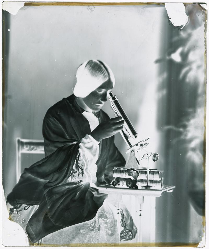 Thereza with microscope, glass negative