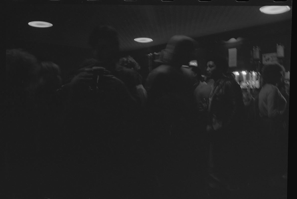 Customers standing near bar in the Dowlais, Butetown.