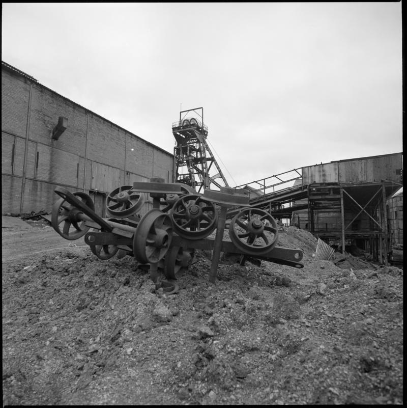Black and white film negative showing a pile of wheels in the colliery yard, Deep Duffryn Colliery.  'Deep Duffryn' is transcribed from original negative bag.