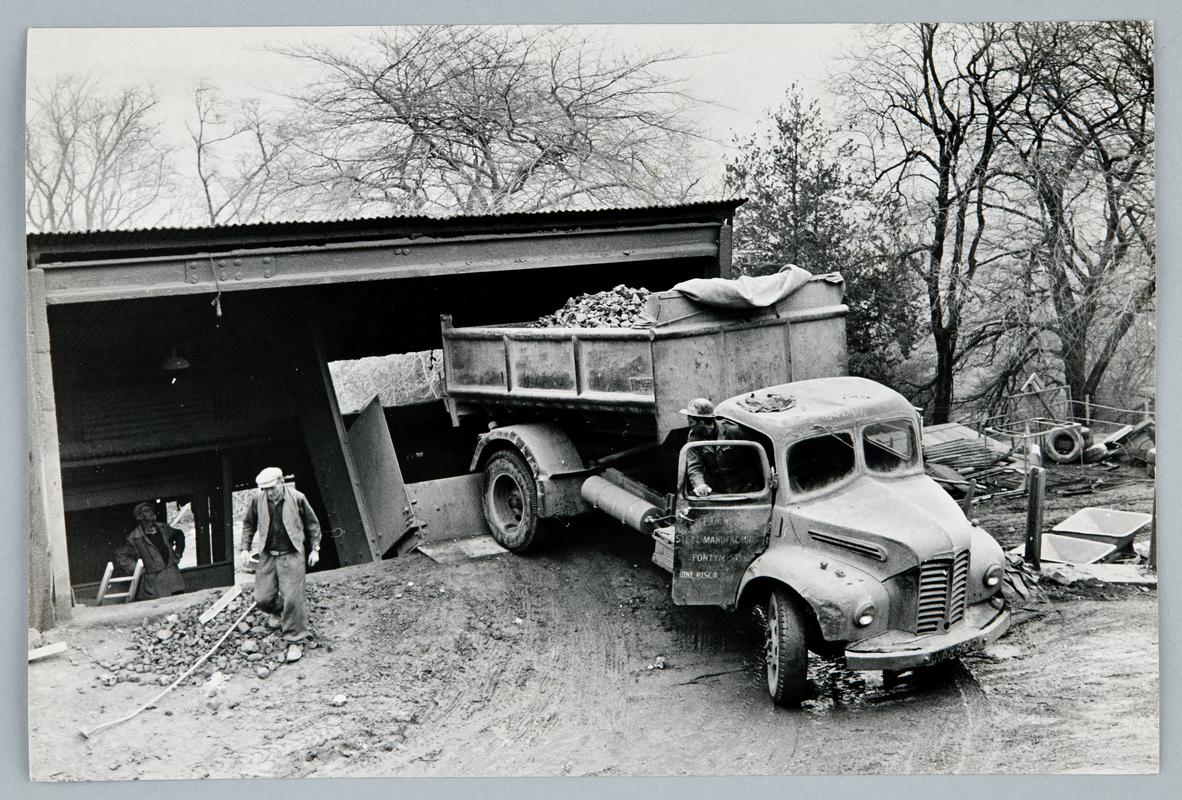 Dolomite quarrying at Ystrad Quarry, Machen. Lorry tipping a load of dolomite into a crusher/hopper.