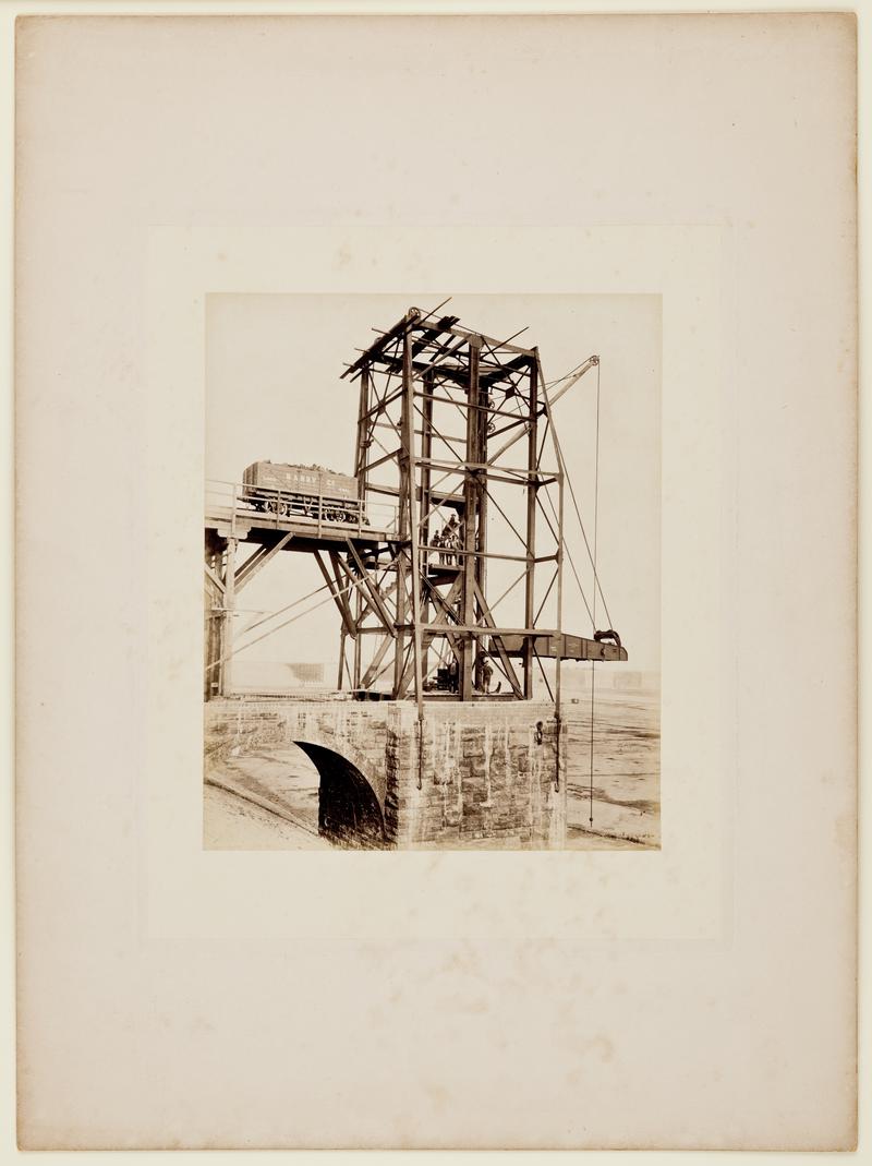 Construction of Barry No. 1 Dock showing nearly completed coal hoist. The full "Barry Co." coal wagon is probably there for advanced publicity purposes. Mounted on card.