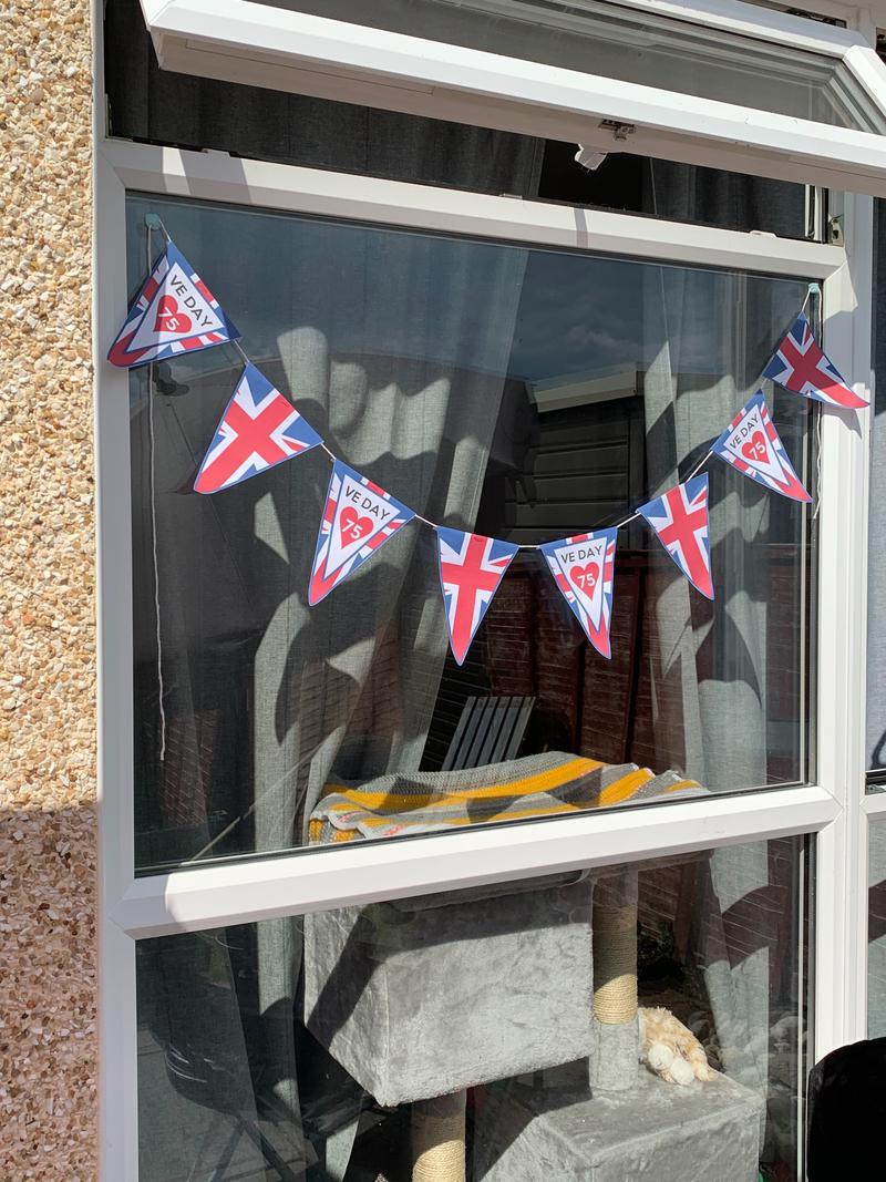 Celebrating VE day from home with Union Jack flags.