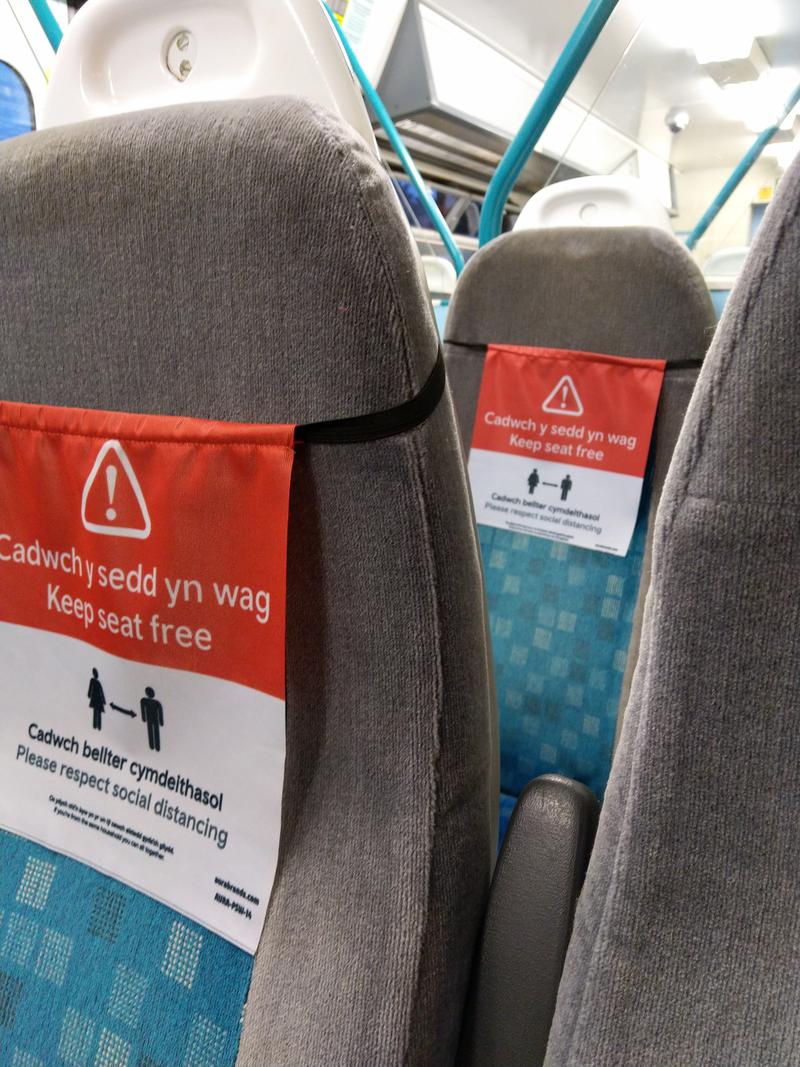'Keep seat free' signs on Transport for Wales train between Radyr and Cardiff.
