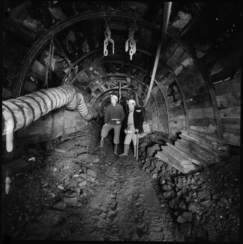 Black and white film negative showing two men underground, ?near Coity shaft, Big Pit Colliery.  Appears to be identical to 2009.3/2993.