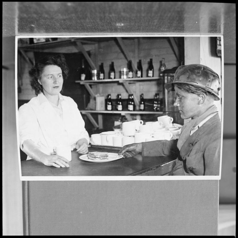 Black and white film negative of a photograph showing a Bevin Boy in the canteen, unknown colliery.