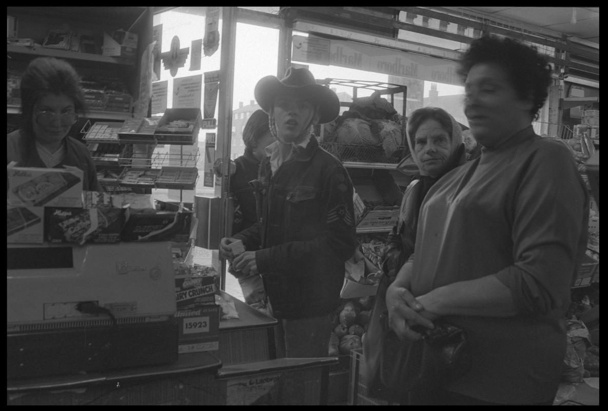 People at cash desk in supermarket, Loudoun Square, Butetown.