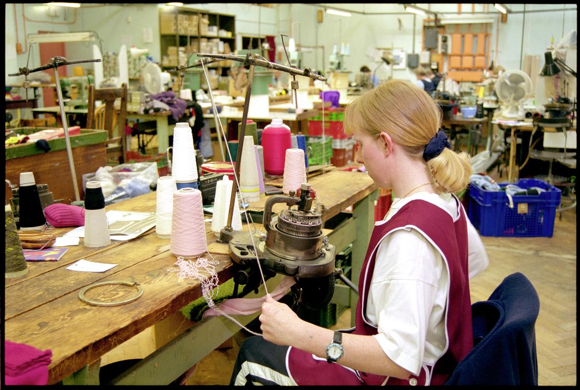 Andrea Rockman operating a hand turned sock knitting machine. Corgi Hosiery Ltd factory, Ammanford, 1 July 2002.