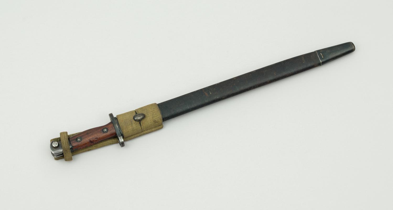 Enfield 17'' bayonet in leather scabbard. For use with an Enfield rifle. Used widely during the First and Second World Wars.