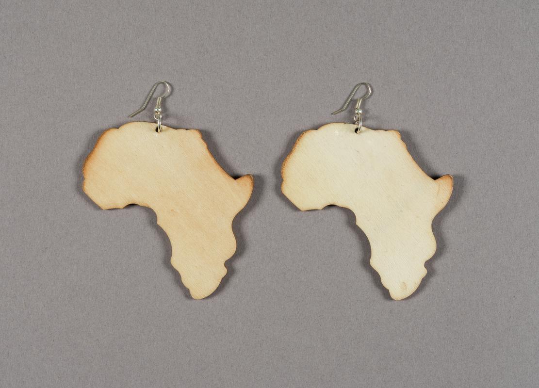 Pair of wooden earrings in the shape of the continent of Africa.