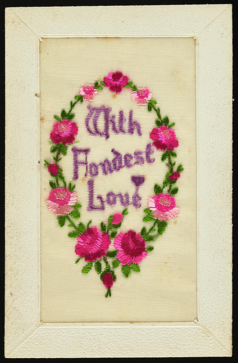 Embroidered silk postcard inscribed With Fondest Love. Sent from France by Gordon Hobbs to his mother during First World War. Dated Aug 22nd 1917. Embroidered oval of pink flowers. Message on back.