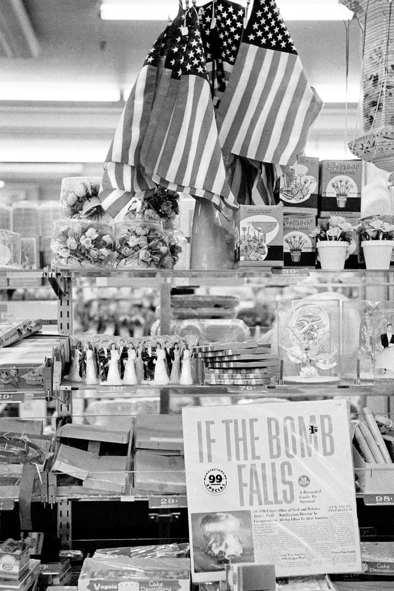 USA. NEW YORK. Lower Manhattan. Woolworth Shop & Ban the Bomb record. Plus the American Flag. 1962.