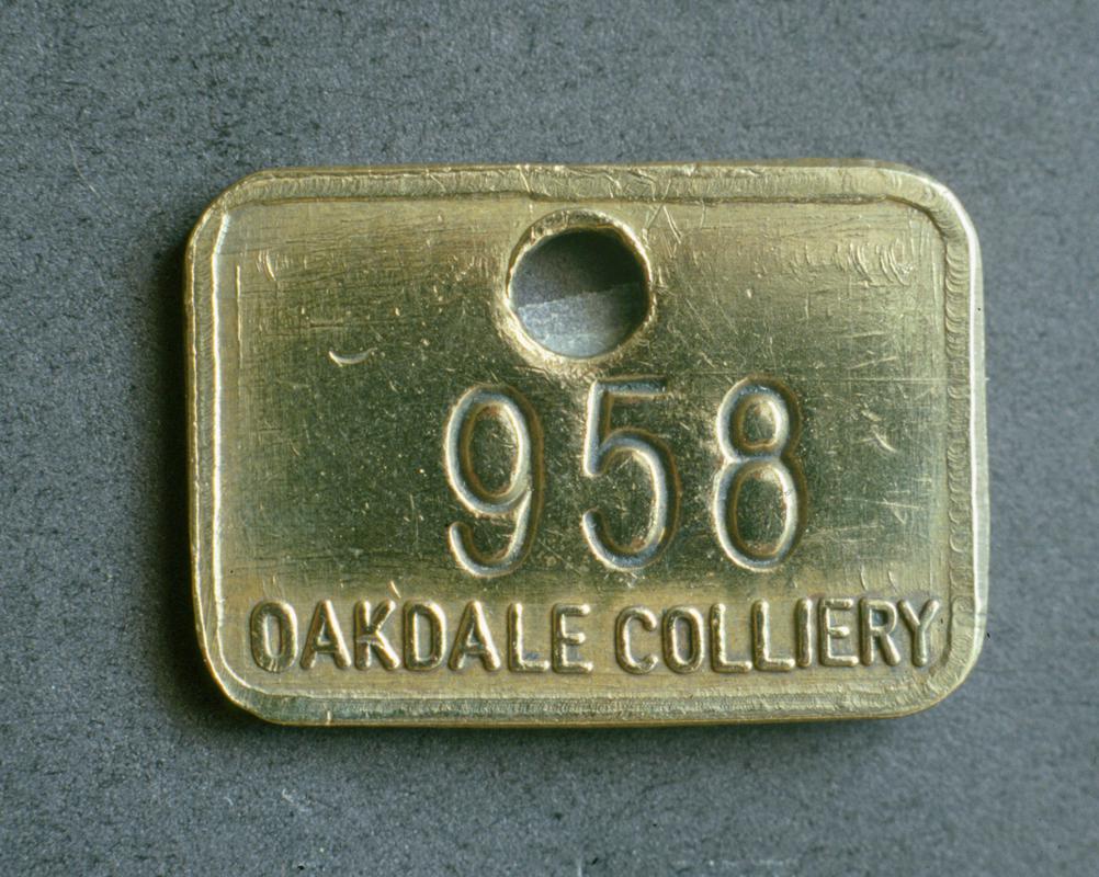 Colour film slide showing an Oakdale Colliery lampcheck engraved '958 OAKDALE COLLIERY'.