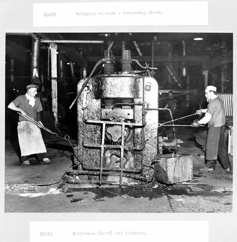 Rollerman (left) and behinder at work either side of mill at Clayton Tinplate Works, Pontarddulais