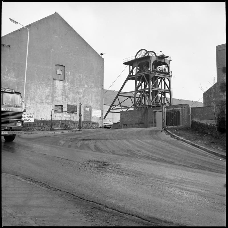 Black and white film negative showing a view of a headframe, Cwm Colliery, April 1981. 'Cwm' is transcribed from original negative bag.