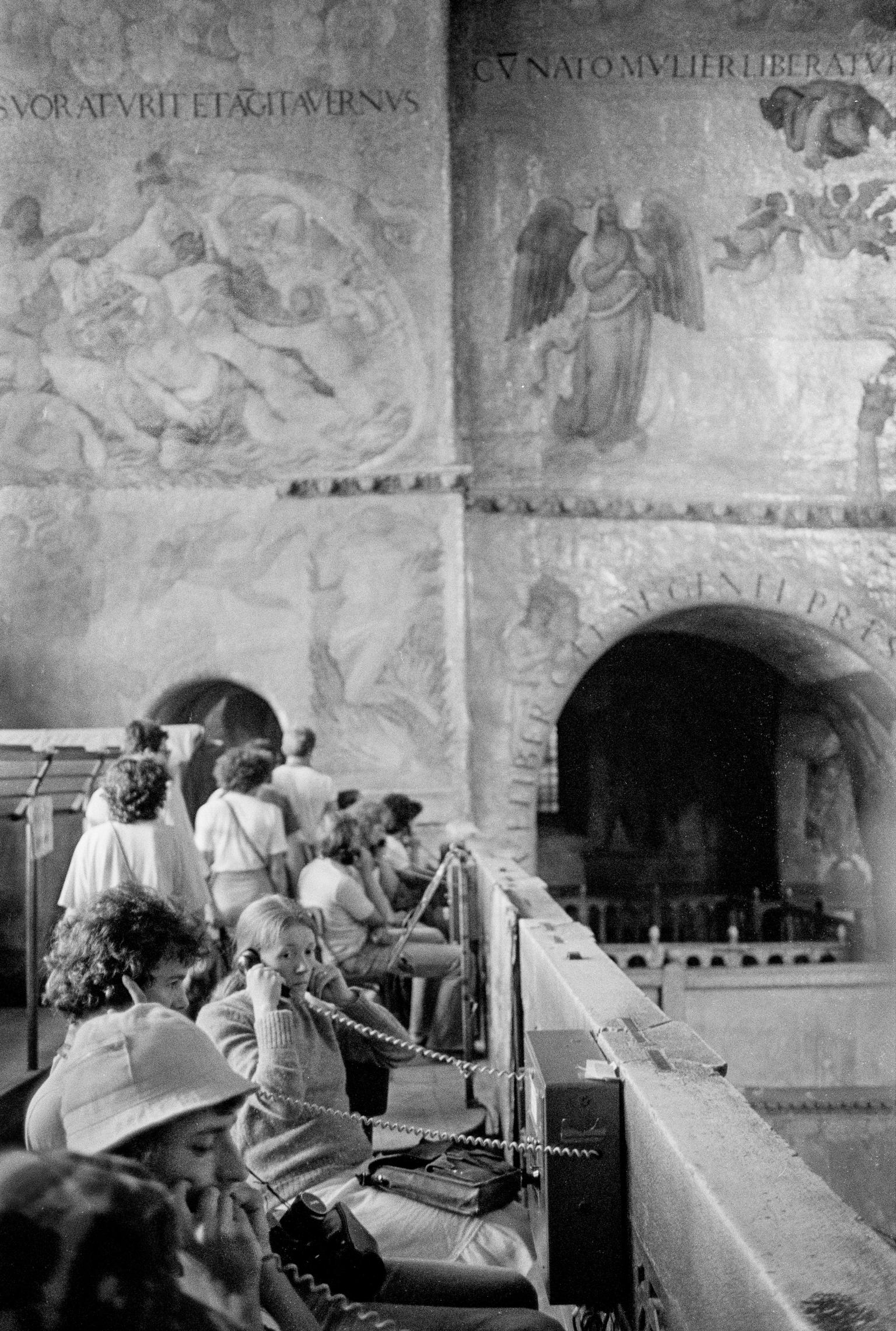 Inside St Marks Basilica Cathedral, tourists listening to history. Venice. Italy