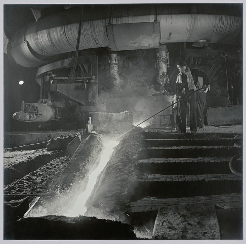 "Blast Furnace, Margam" tapping the blast furnace (shows bustle pipe, injecting super heated air) - Photograph of steelworks and South Wales
