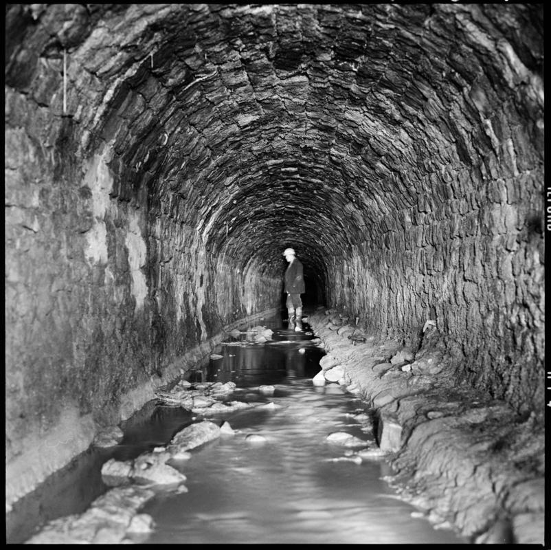 Black and white film negative showing a man at the River Arch Level, Big Pit.