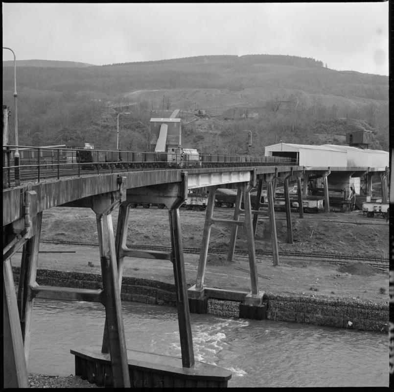 Black and white film negative showing a concrete viaduct spanning the river linking the mine with the washery, Blaengwrach Colliery 1978.  '1978' is transcribed from original negative bag.