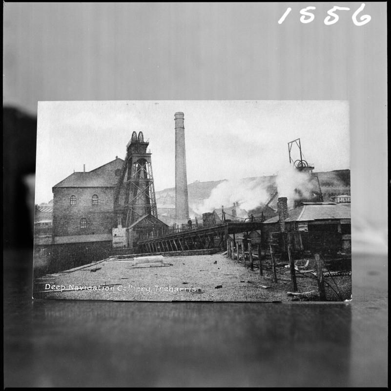 Black and white film negative of a postcard? showing a general surface view of Deep Navigation Colliery.  Bottom of postcard reads 'Deep Navigation Colliery, Treharris'.  'Deep Navigation' is transcribed from original negative bag.