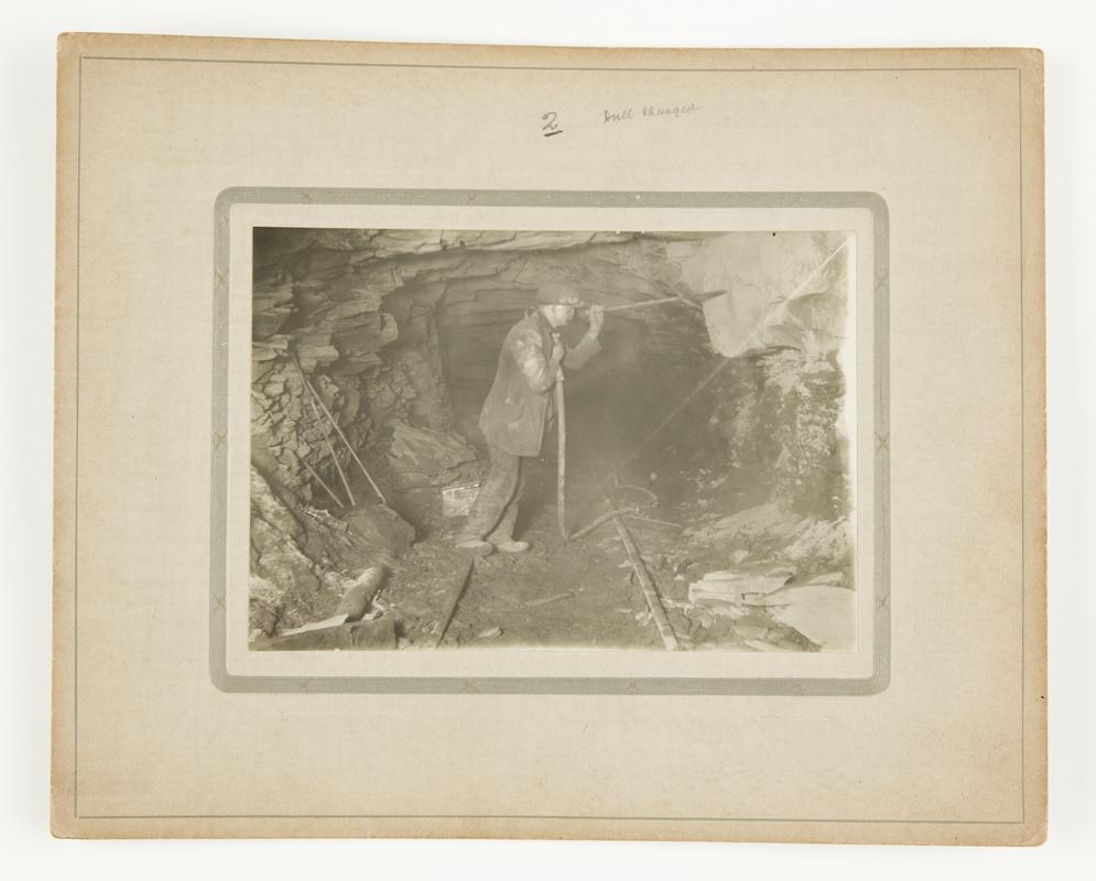 Photograph showing Stan Williams' dust trap invention in action underground. Mounted on card.