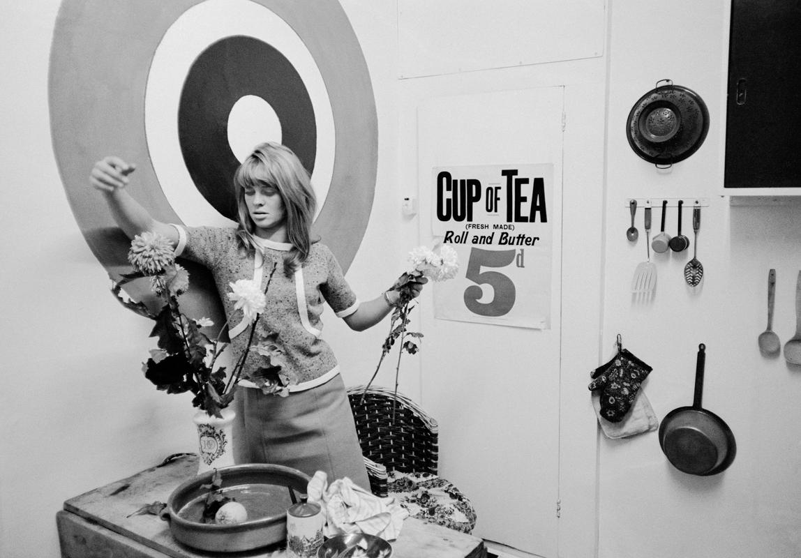 GB. ENGLAND. London. Young Julie Christie making flower arrangement in her London flat. 1965.