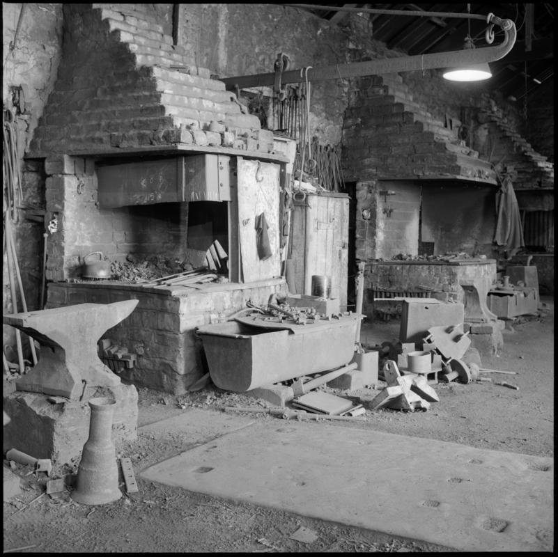 Black and white film negative showing the interior of the blacksmith workshop, Big Pit Colliery 1975.  'Blaenavon 1975' is transcribed from original negative bag.