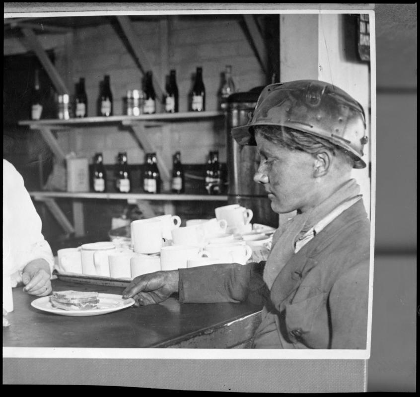Black and white film negative of a photograph showing a Bevin Boy in the canteen, unknown colliery.  'Bevin Boy' is transcribed from original negative bag.